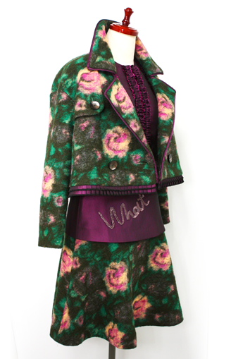 デザインの細部にまでこだわられたグリーンのフェルト生地のジャケットとスカート、そしてボルドーのブラウス 